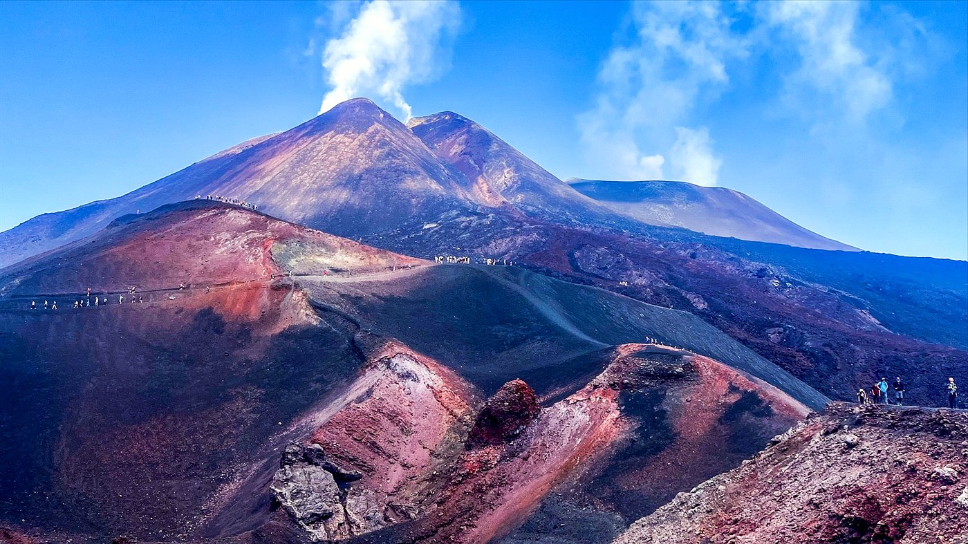 Etna cable car and 4x4 trek view over red and black craters below the summit